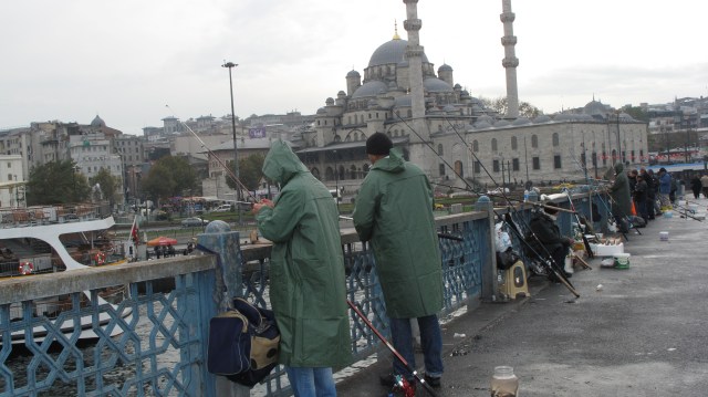 Fishermen on Galata Bridge, Istanbul, Suleymaniye Mosque in background
